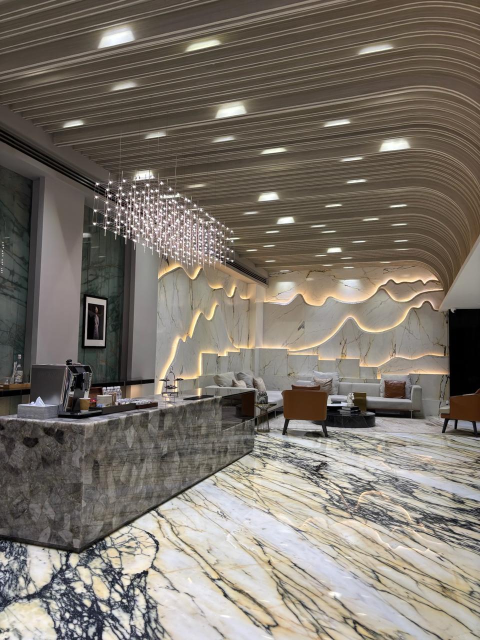 Lounge with sculpted marble mountain-motif wall and crystal chandelier